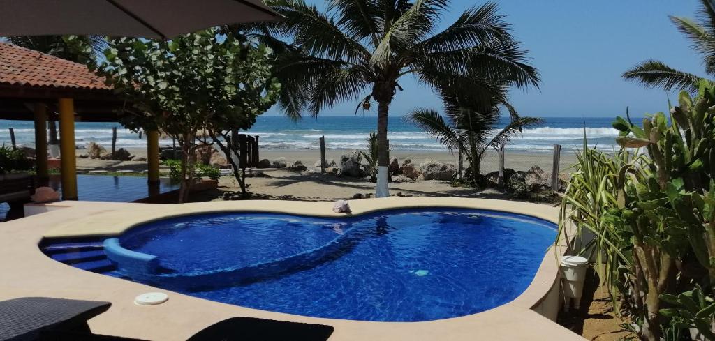 a swimming pool with the beach in the background at Casa La Quinta Ola in Troncones