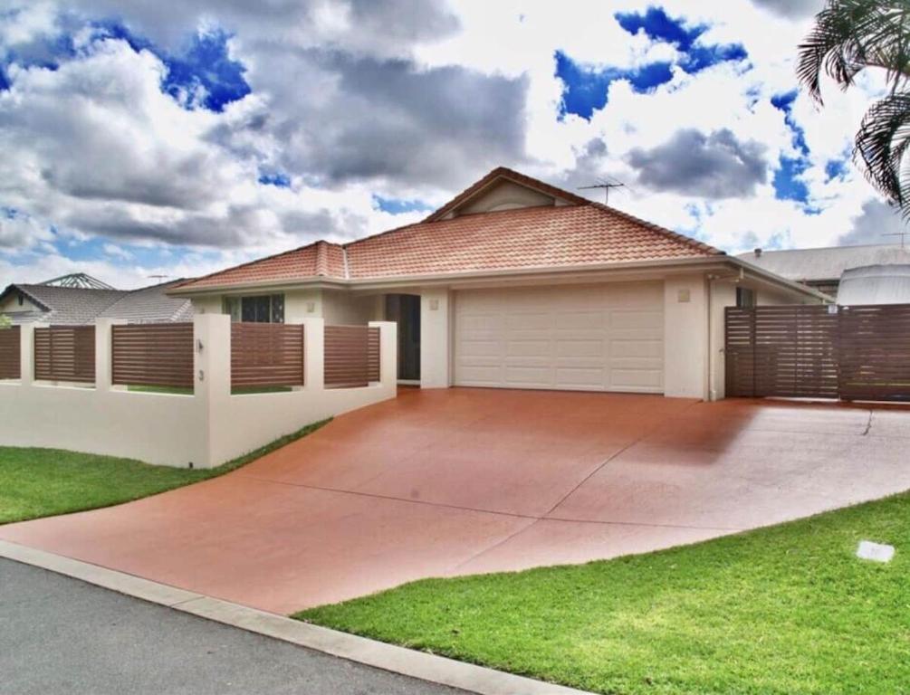 a house with a driveway in front of it at Immaculate House, Indulgent Living! in Brisbane