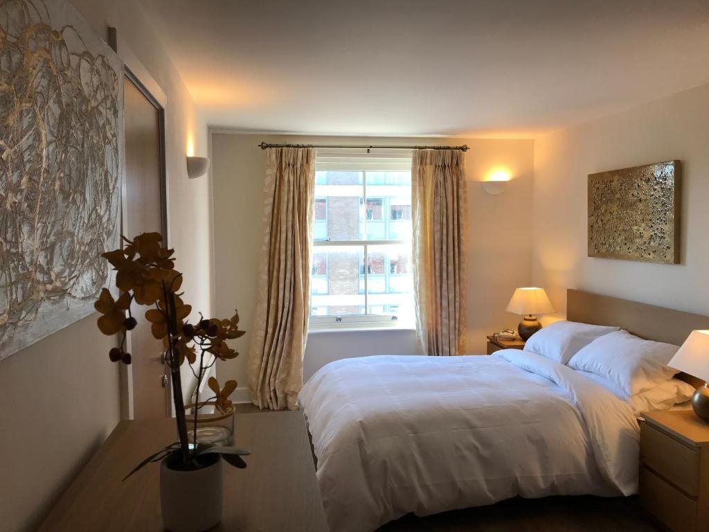 a bedroom with a white bed and a window at Flagstaff Court in Kent