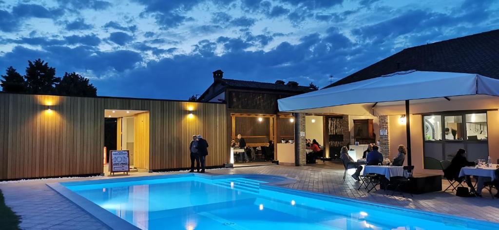 a swimming pool in front of a house at night at Agriturismo-R&B Corte dei Gioghi in Ferrara