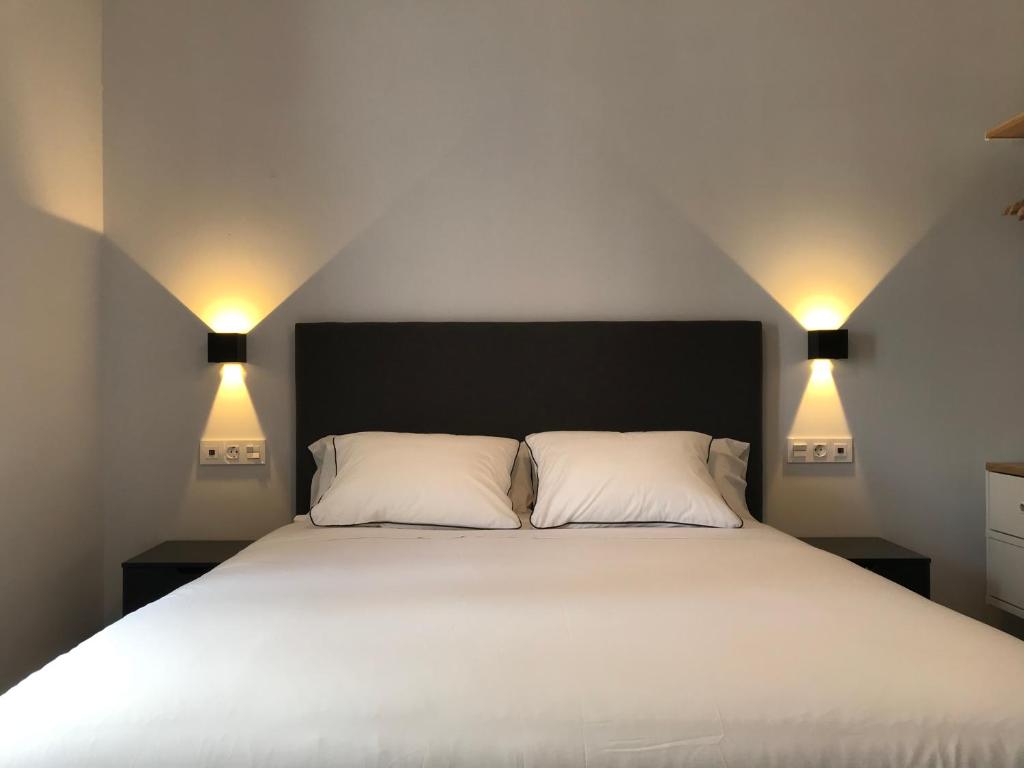 Posteľ alebo postele v izbe v ubytovaní Apartamentos Ciudad de Ronda