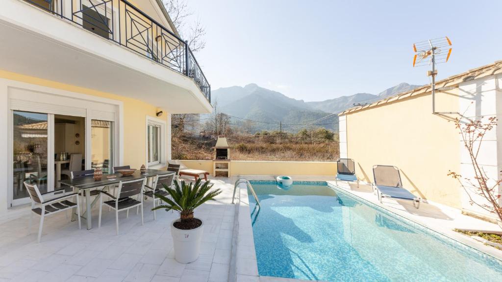 a villa with a swimming pool and a patio at Diamanti Villa, Pool & Barbecue in Skala Potamias