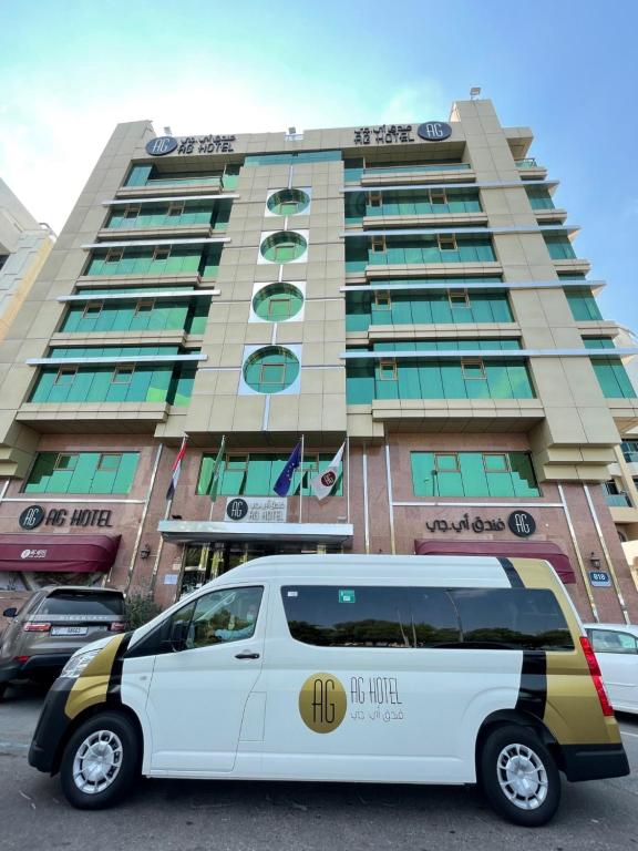 a white van parked in front of a building at AG Hotel in Abu Dhabi