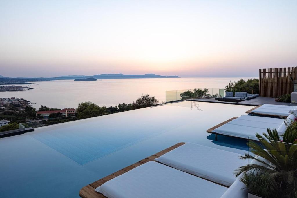 a swimming pool with a view of the water at Regal Residence in Chania Town