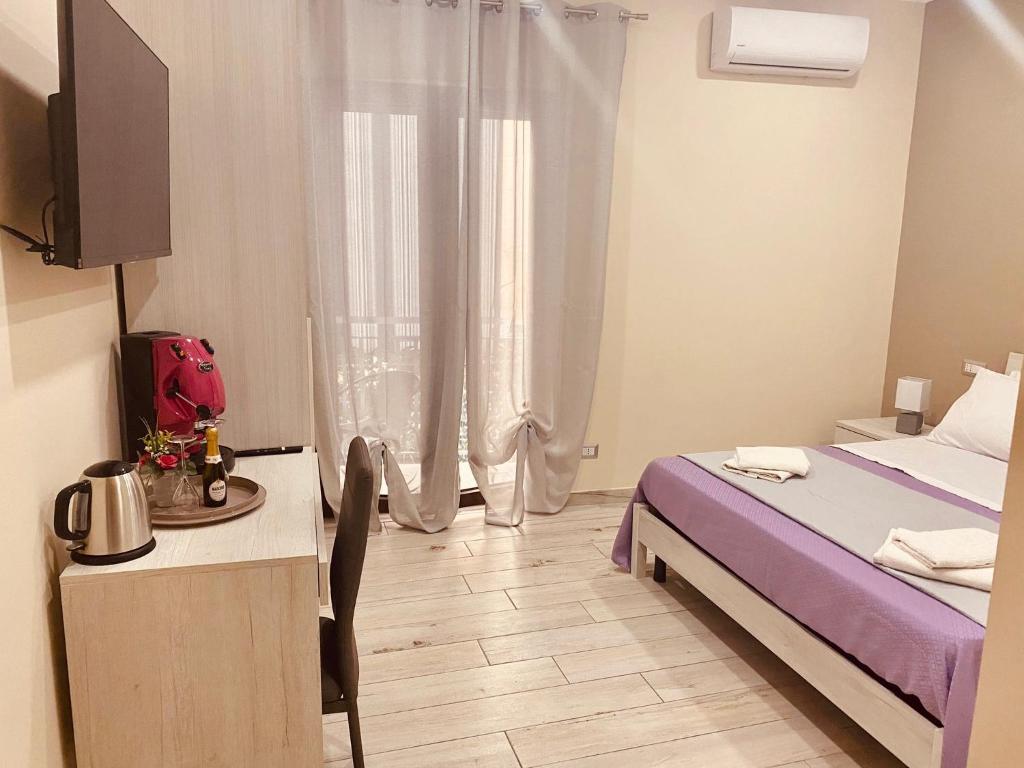 Postel nebo postele na pokoji v ubytování YourHome - La Meta Perfetta Rooms&Spa