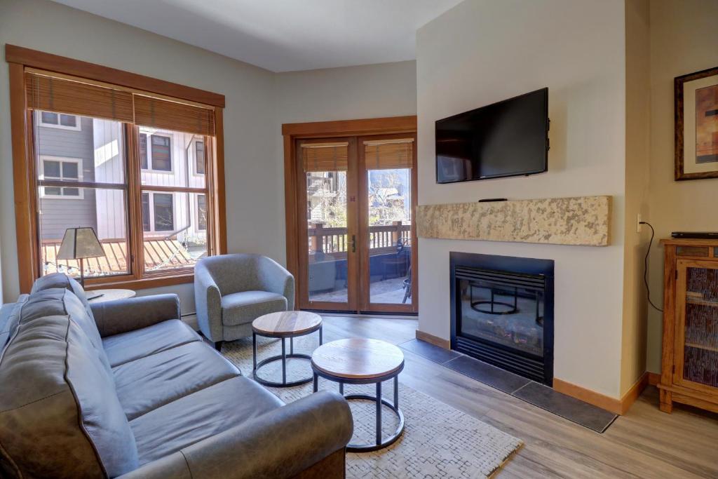 a living room with a couch and a fireplace at Co204 Copper One Lodge Condo in Copper Mountain