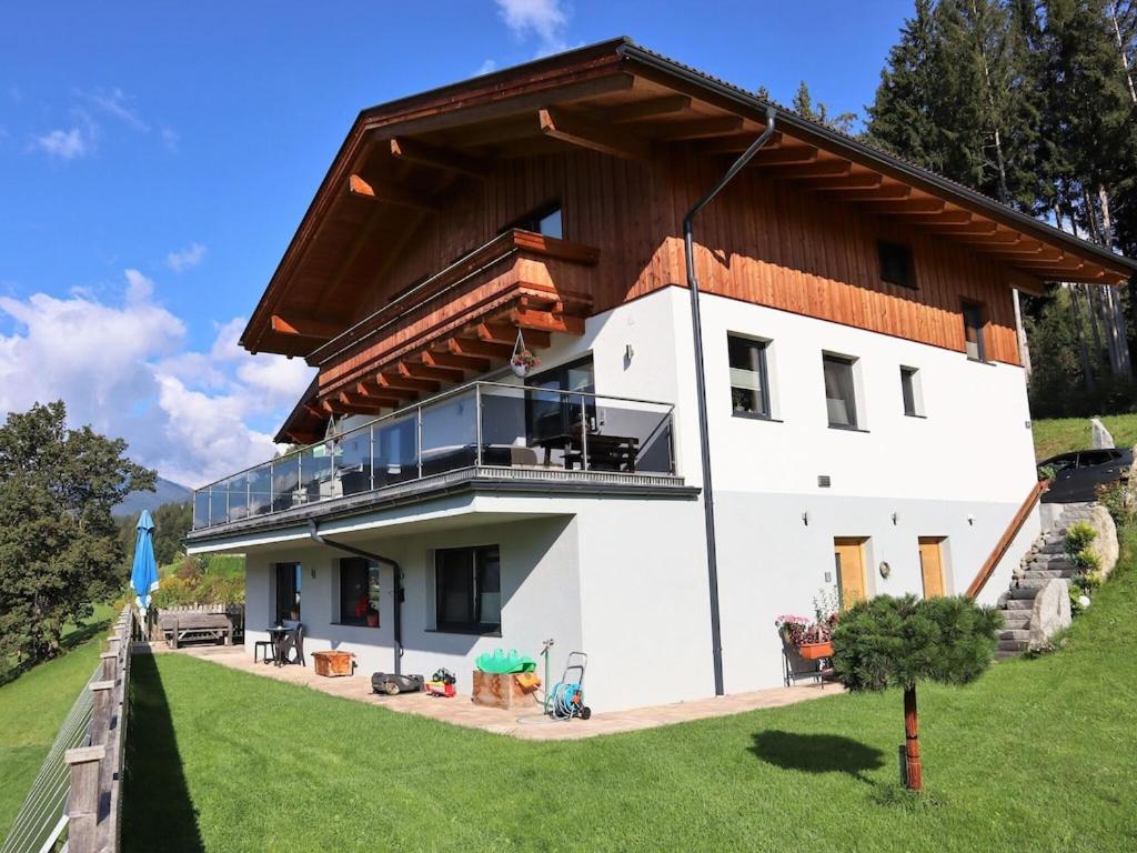 a large white house with a wooden roof at Apartment Lemberger in Mittersill