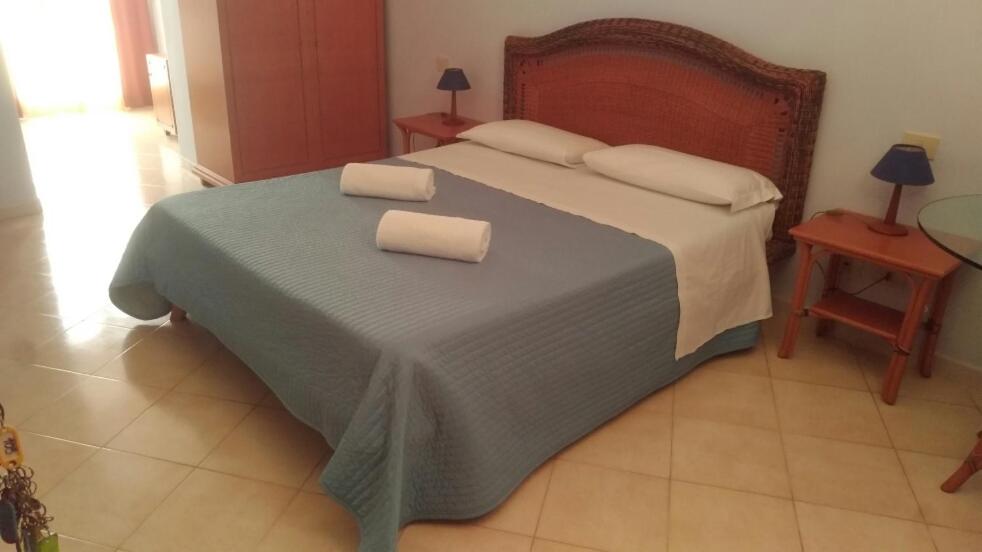 a bedroom with a bed with two towels on it at B Palace in Ardea