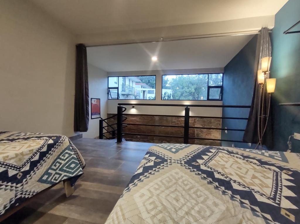 Una cama o camas en una habitación de Casona San Cayetano Suites & Lofts by SCE