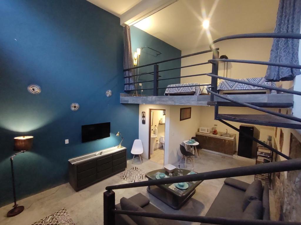 a living room with a loft bed and a couch at Casona San Cayetano Suites & Lofts by Lunian in Guanajuato