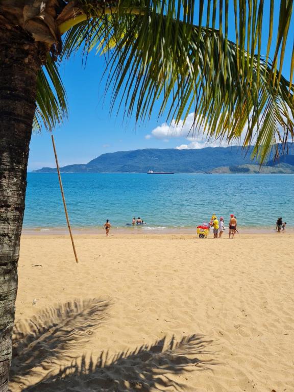 a group of people playing on the beach at Pousada Por do Sol in Ilhabela