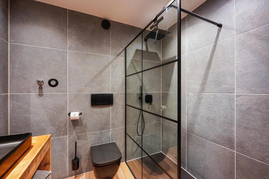 a shower with a glass door in a bathroom at Allgäu Chalet mit Berg-Panorama in Oberreute