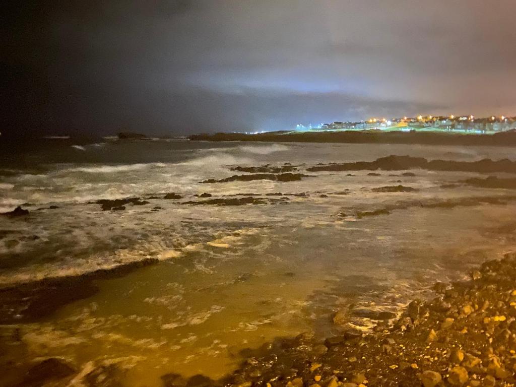 a view of the ocean at night at Ocean Hideaway @ Portmore Bay in Portstewart