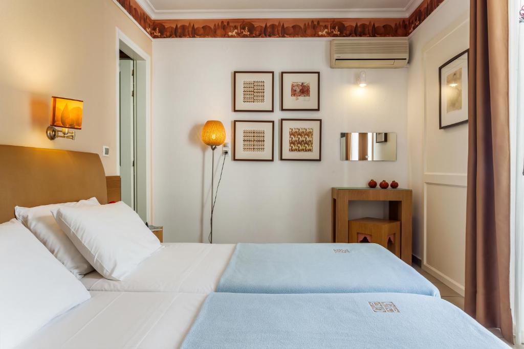 Postel nebo postele na pokoji v ubytování Hotel Akti