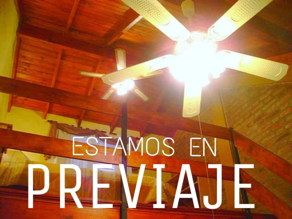 a ceiling fan with the words stanzas in prepare at Cabaña Newen in Capilla del Monte