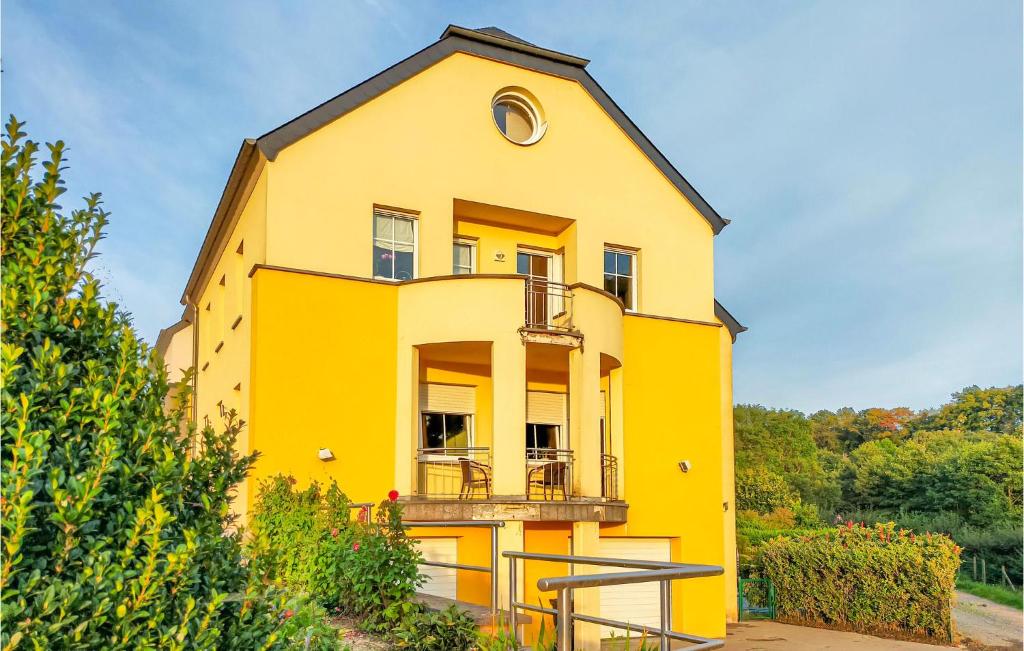 a yellow house with a black roof at 2 Bedroom Awesome Apartment In Winseler in Winseler