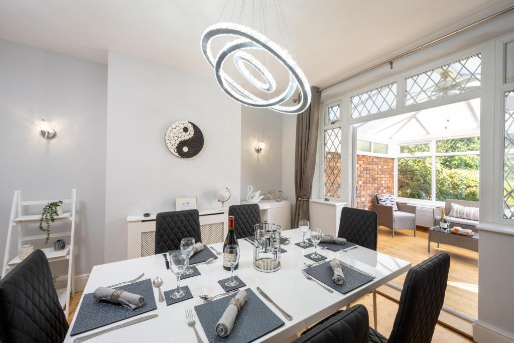comedor con mesa blanca y sillas en Mulberry House - Luxurious and Modern 4-Bed in Solihull near NEC,JLR, Airport, Resorts World, HS2, en Solihull