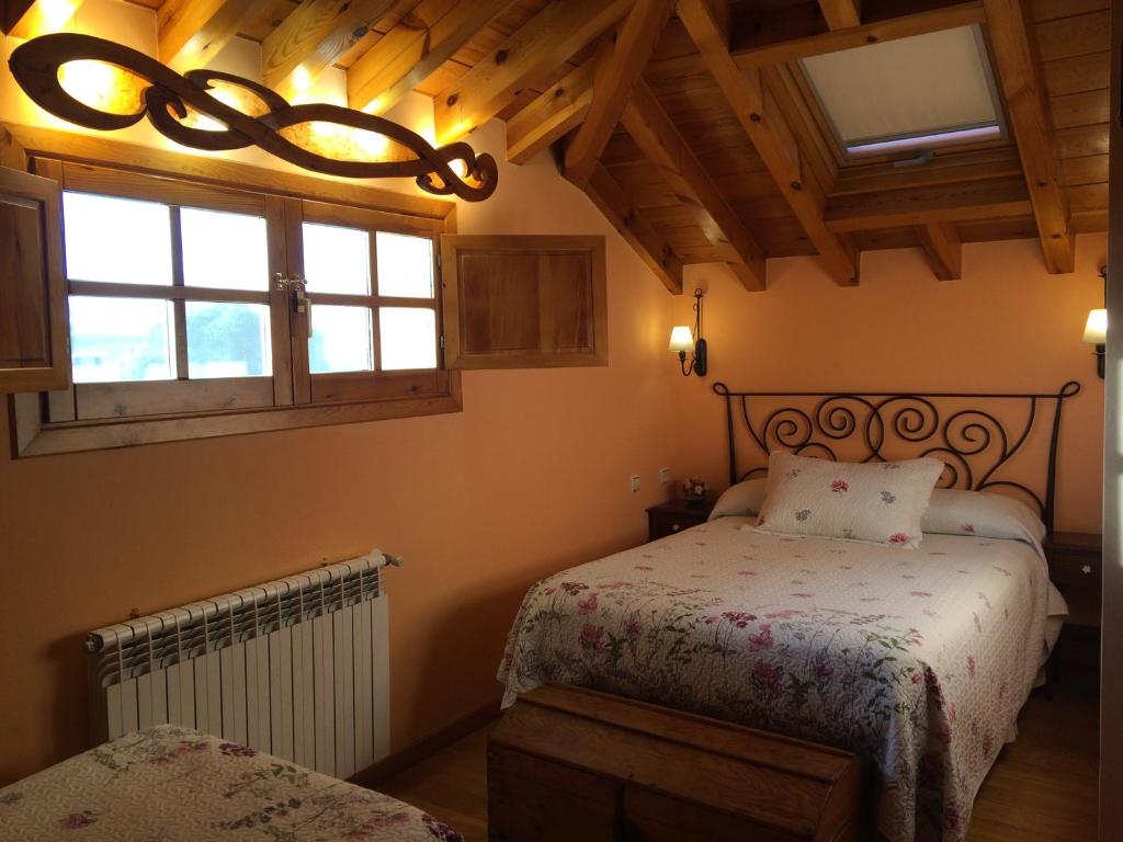 a bedroom with a bed and a window at La Casa de Bernuy in Bernúy de Porreros