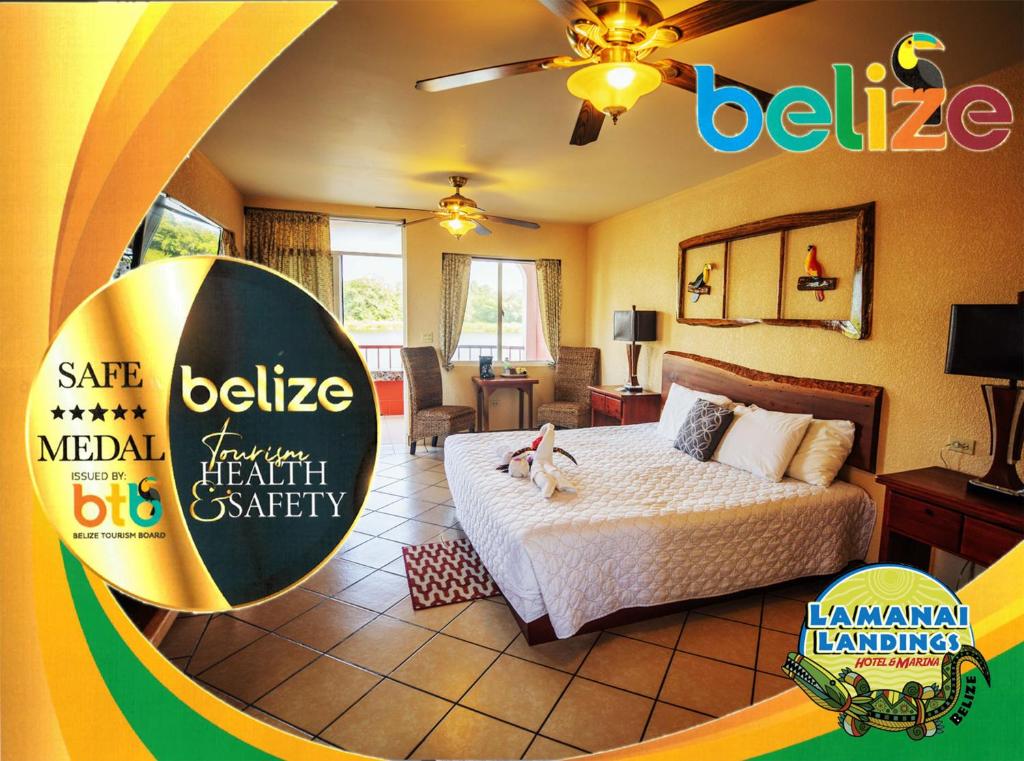 a bedroom with a bed and a sign that says belize medical benefit society at Lamanai Hotel & Marina in Orange Walk