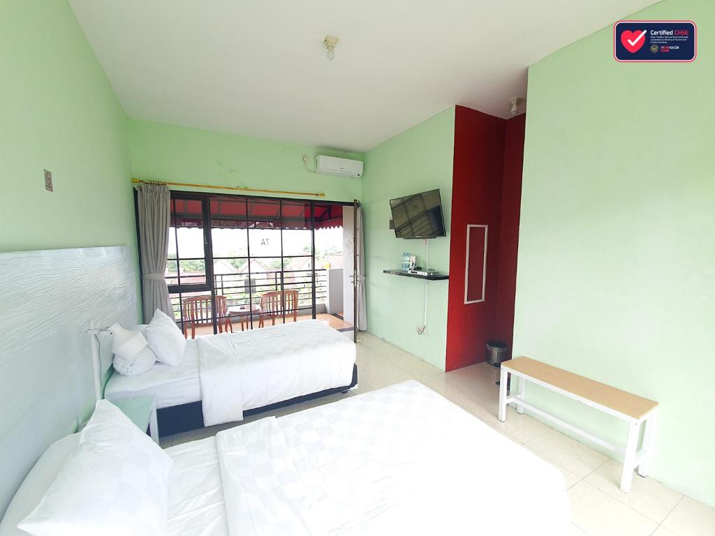 Postel nebo postele na pokoji v ubytování Hotel Griya Wijaya