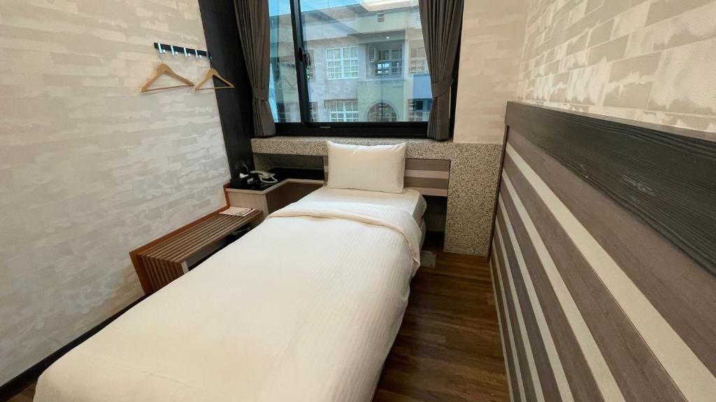 Una cama o camas en una habitación de Weifeng Boutique Business Hotel - Zhanqian Branch