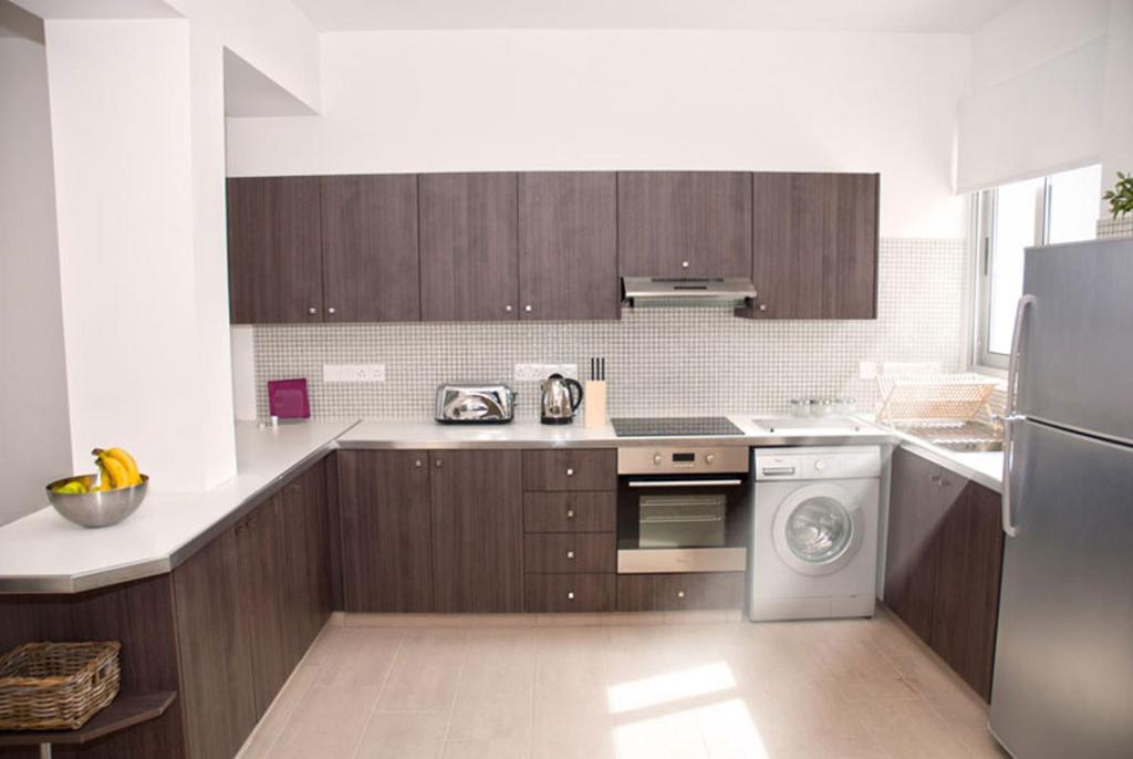 Kuchyň nebo kuchyňský kout v ubytování Napian Suites