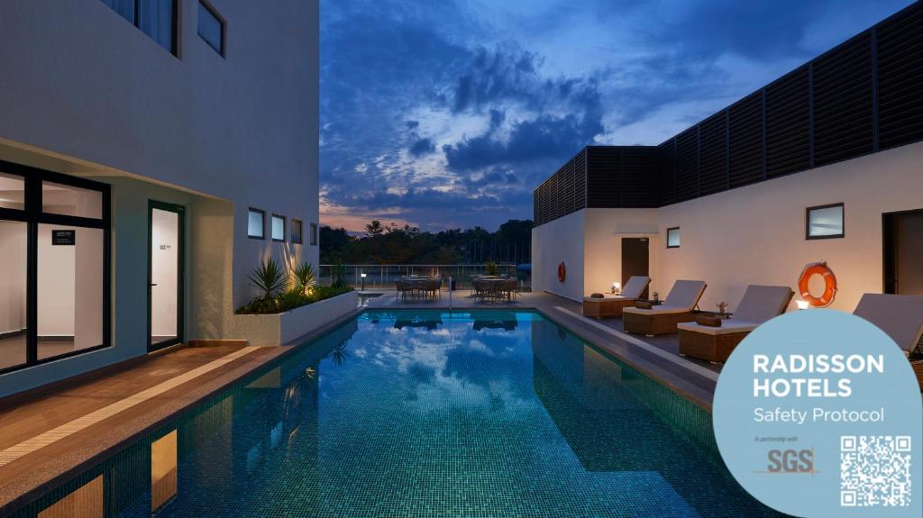 a swimming pool in the middle of a house at Park Inn by Radisson Putrajaya in Putrajaya