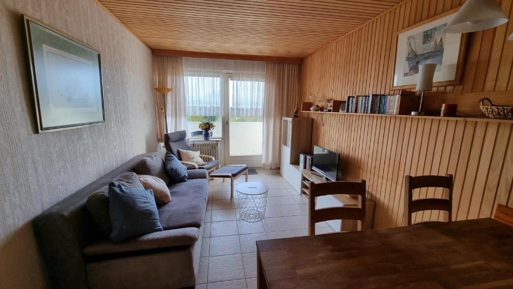 a living room with a couch and a table at Ferienwohnung L412 für 2-4 Personen an der Ostsee in Schönberg in Holstein