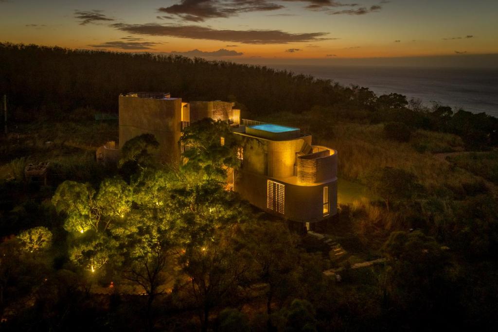 an aerial view of a house on a hill with lights at 灣臥民宿 Wandering Walls in Hengchun South Gate