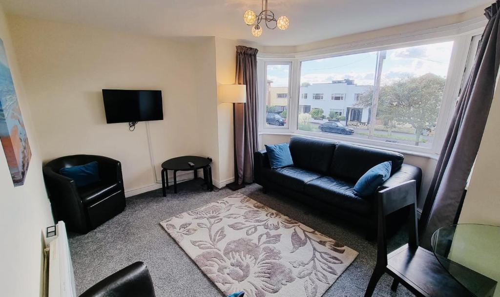 a living room with a couch and a window at Lovely 2-Bed Apartment Central Skegness Beach in Skegness