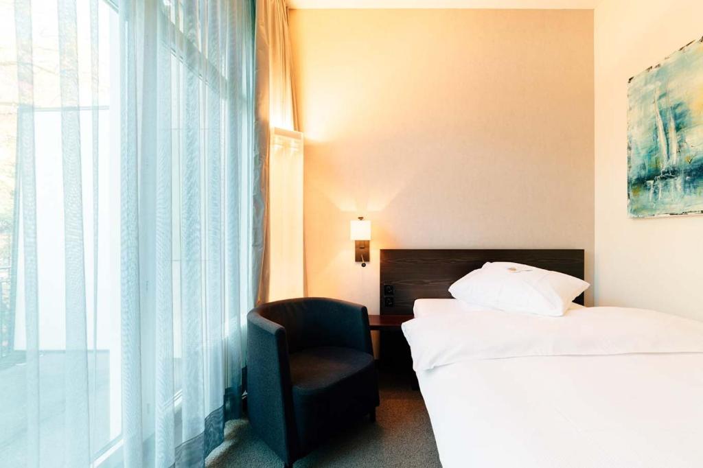 Postel nebo postele na pokoji v ubytování Park Hotel Winterthur