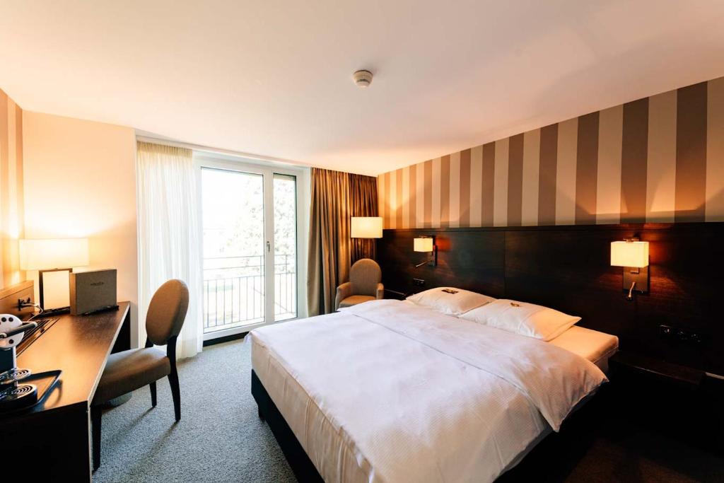 Postel nebo postele na pokoji v ubytování Park Hotel Winterthur