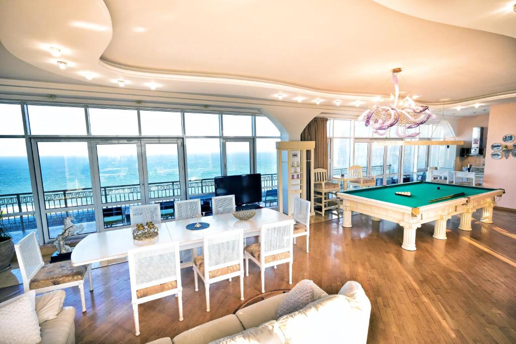a living room with a pool table at Arkadia Palace Luxury Apartments in Odesa