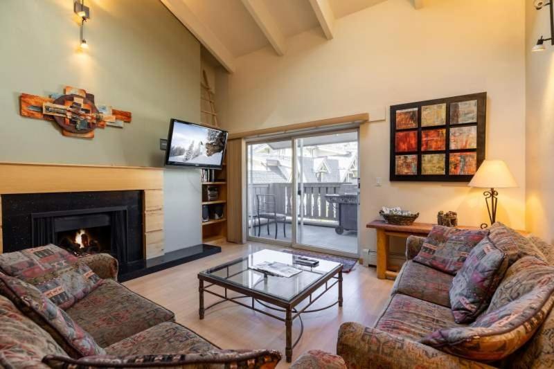 a living room with two couches and a fireplace at Condo with Hot Tub Free Garage Parking in Vail