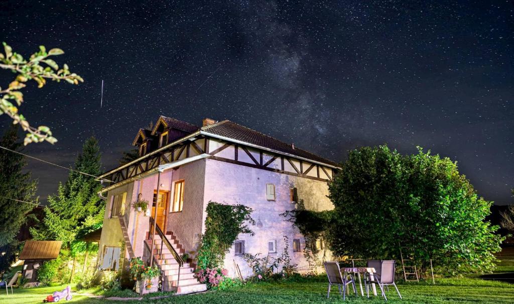 an old house with a starry sky behind it at Apartment at Sedliacky Dvor - Brezno in Brezno