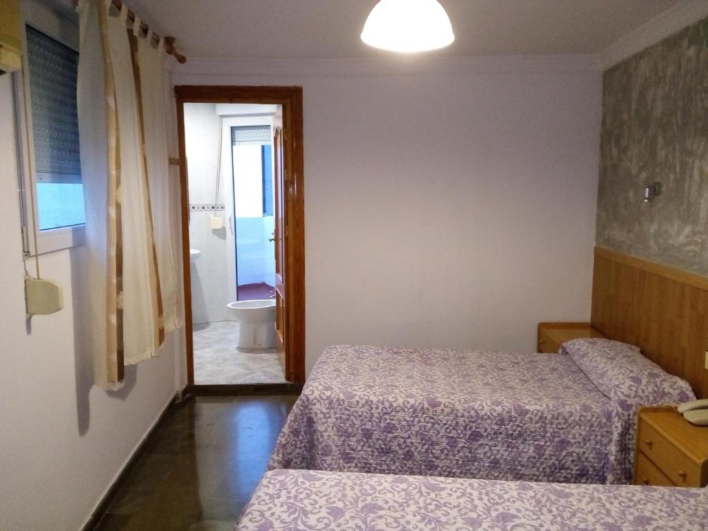 Postel nebo postele na pokoji v ubytování Hostal Manolete