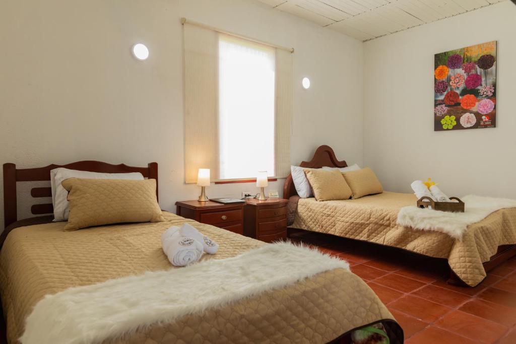 Postel nebo postele na pokoji v ubytování hotel villa claudia