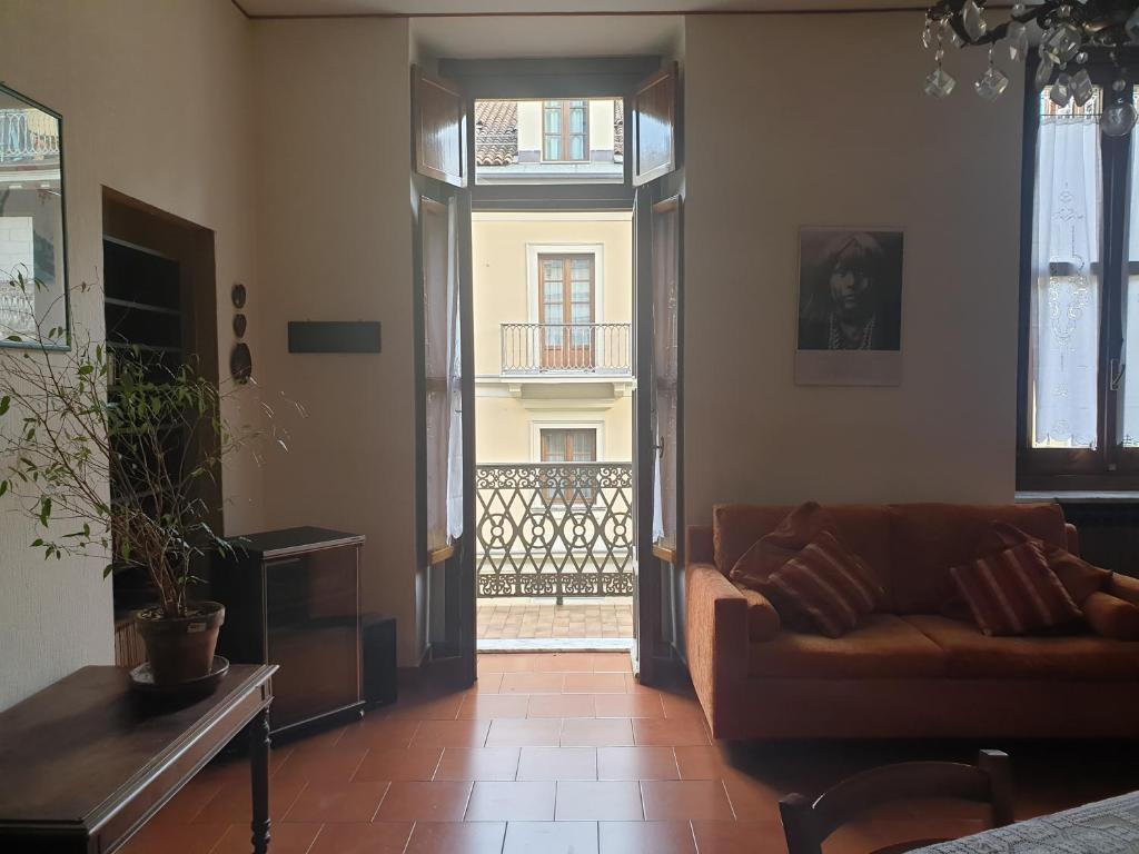 a living room with a couch and a balcony at La casa di Chicca in Turin
