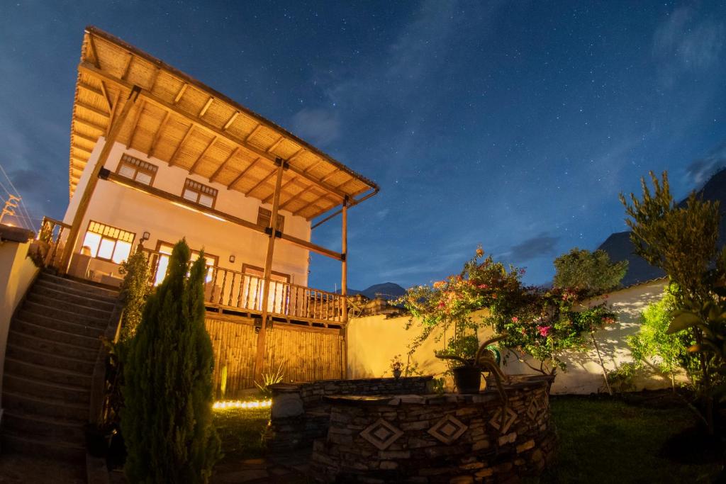 a house with a staircase leading to it at night at Alpa Kamaska Casa Hospedaje in Nuevo Tingo