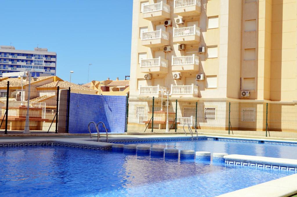 a swimming pool in front of a building at Villa Cristal 5608 - Resort Choice in La Manga del Mar Menor