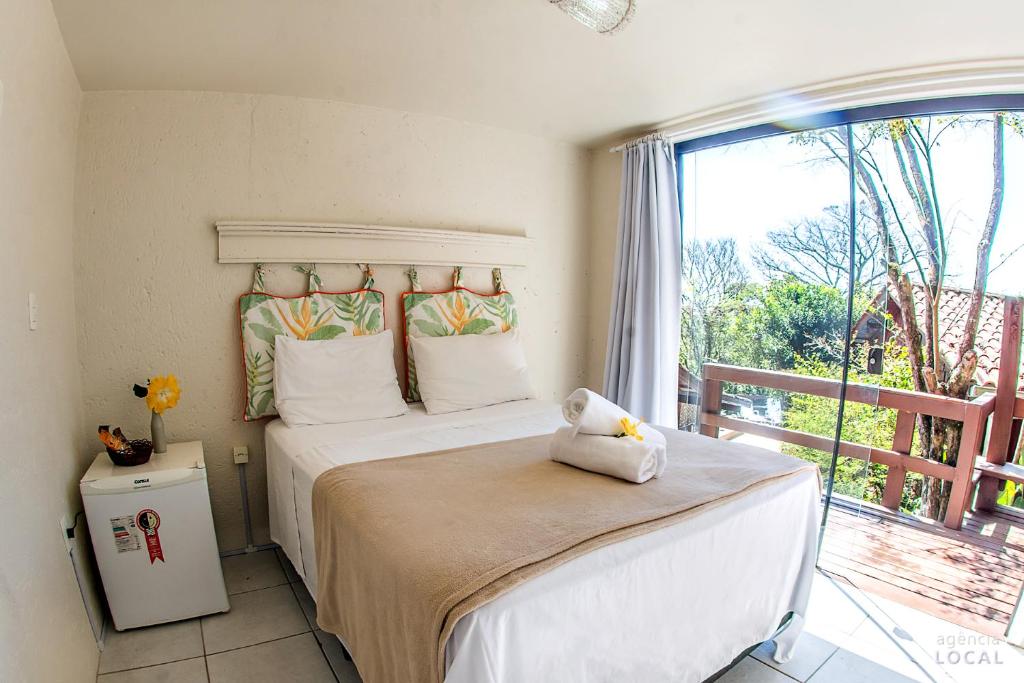 Cama ou camas em um quarto em Pousada Rosa