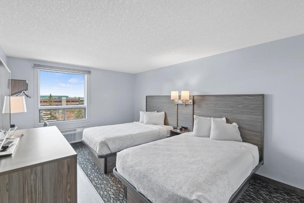 Postel nebo postele na pokoji v ubytování Emerald Hotel & Suites Calgary Airport