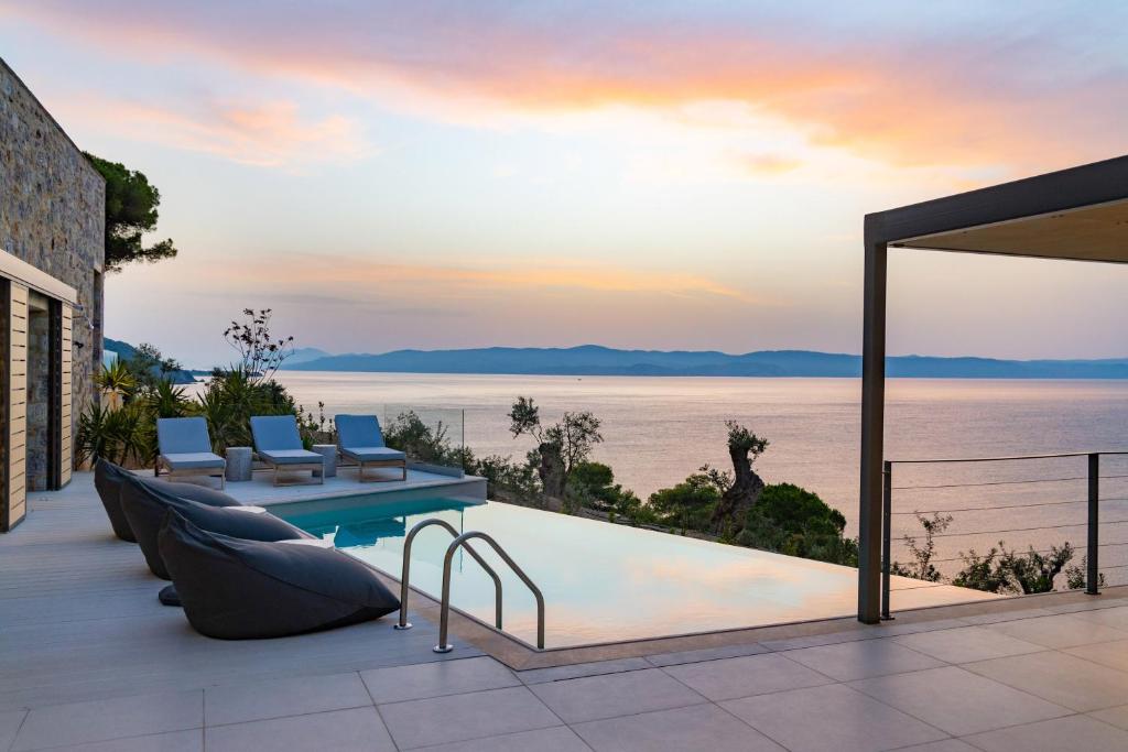 a view of the water from a house with a swimming pool at Kechria Bay Villas in Skiathos