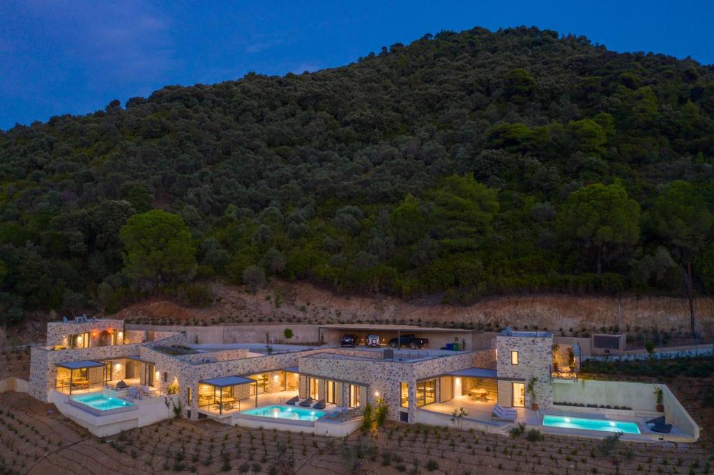 an aerial view of a house with a mountain in the background at Kechria Bay Villas in Skiathos