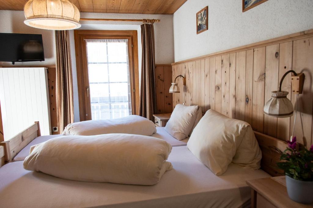 a room with two beds with pillows on it at Alpina B&B Apartments in Sta Maria Val Müstair