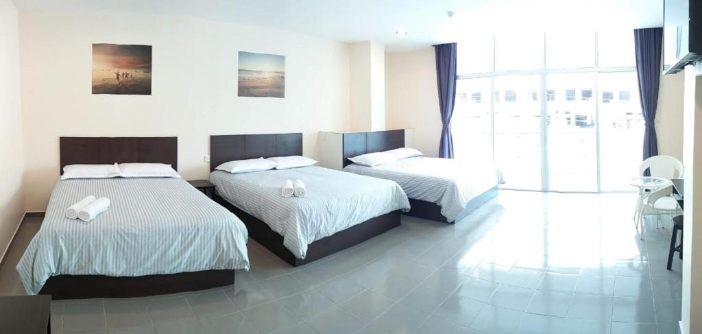 Postel nebo postele na pokoji v ubytování Hotel Pangkor SJ
