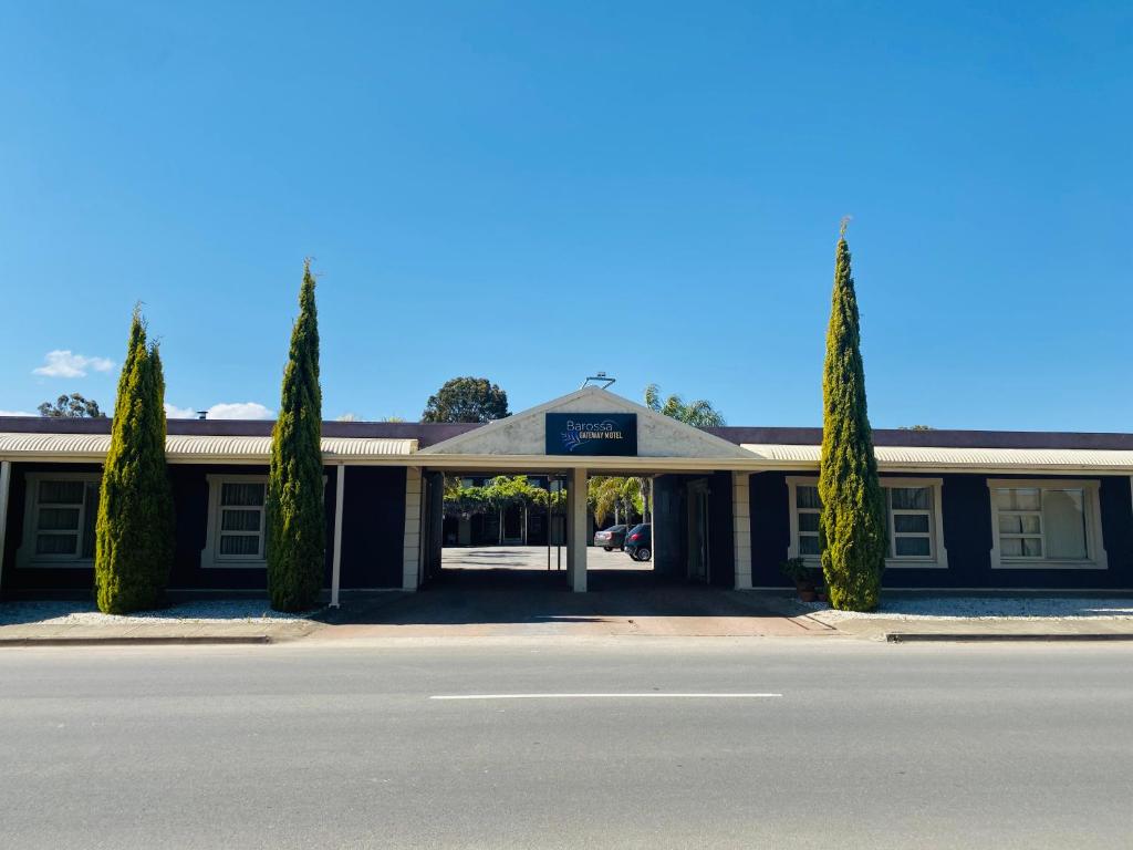 a building with trees in front of a street at Barossa Gateway Motel in Nuriootpa