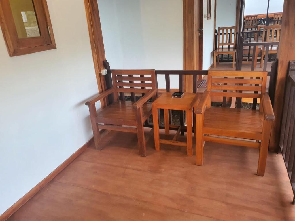 a dining room with wooden chairs and a table at Rinjani Camp Sajank in Sajang