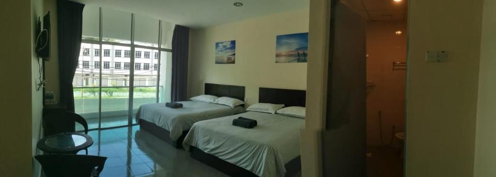 Postel nebo postele na pokoji v ubytování Hotel Pangkor SJ