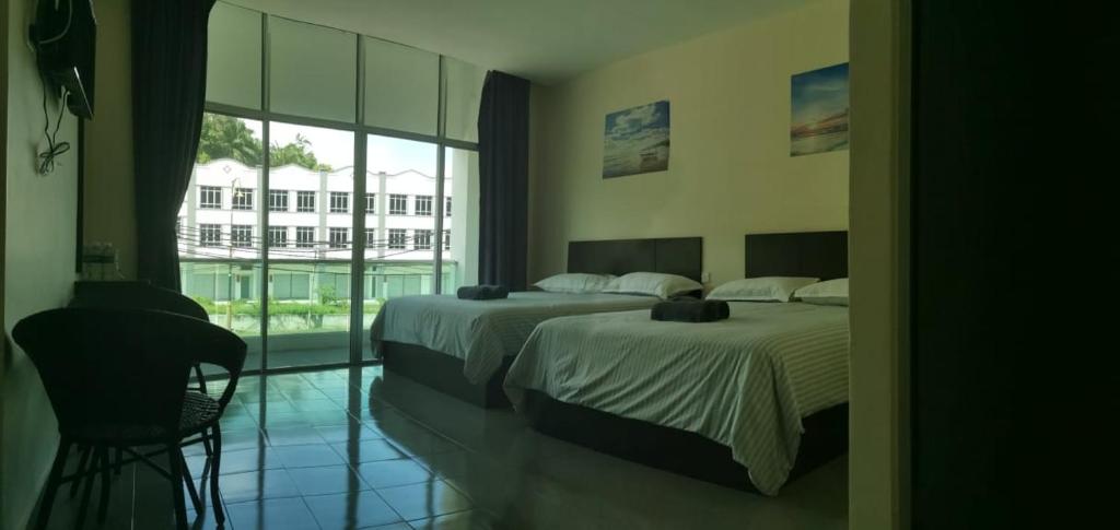 Postel nebo postele na pokoji v ubytování Hotel Pangkor SJ